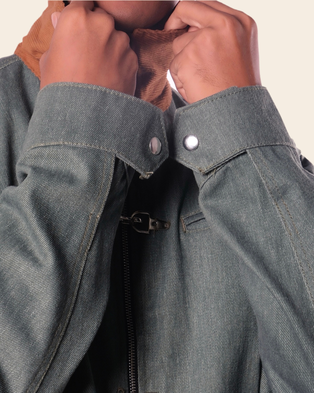 Close-up of a person wearing a green jacket with a buttoned collar.