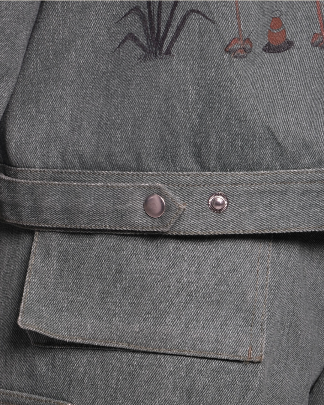 Gray fabric with embroidered designs on a garment