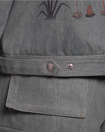 Gray fabric with embroidered designs on a garment