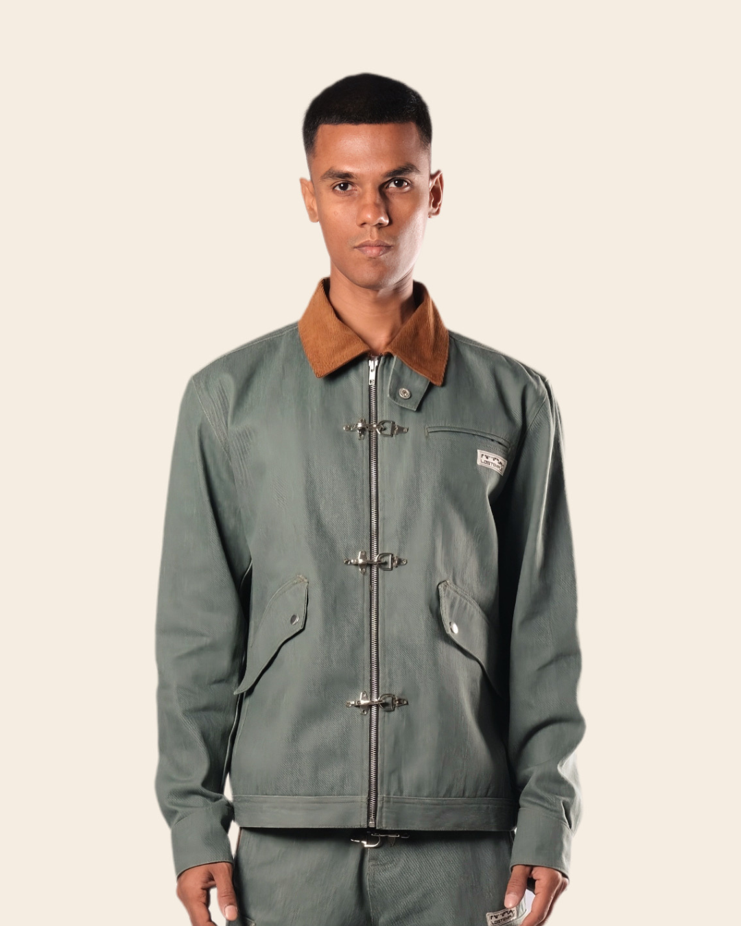 Man wearing a green jacket with a brown collar on a beige background