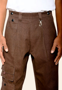Brown cargo pants with buttons and a hook on a beige background
