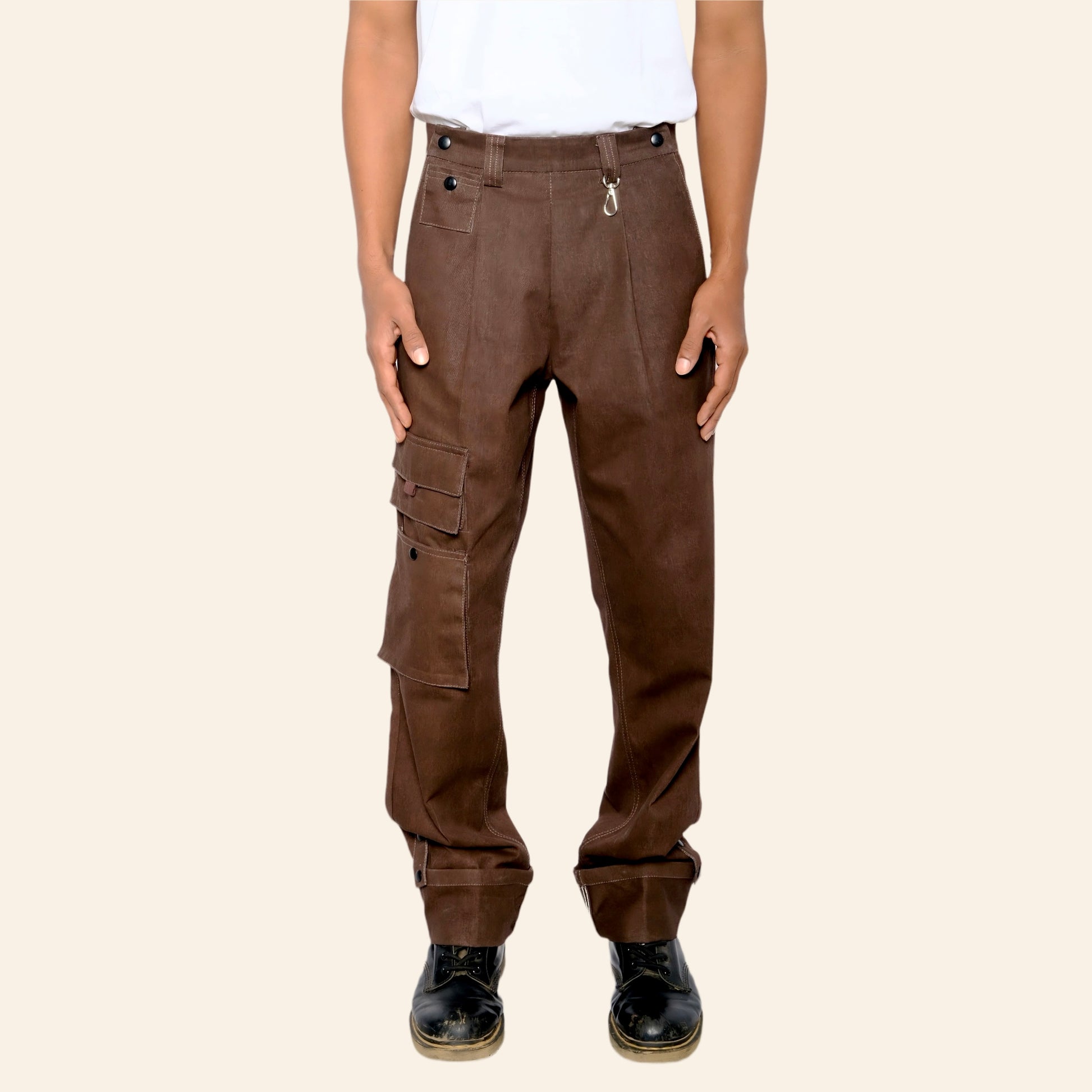 Brown cargo pants worn by a person on a beige background